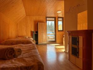 a bedroom with two beds and a wooden ceiling at Chalet Pohoda in Donovaly