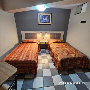 Postel nebo postele na pokoji v ubytování Hostal La Cascada