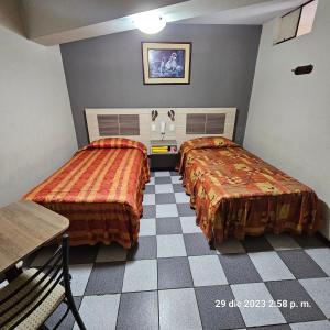 Postel nebo postele na pokoji v ubytování Hostal La Cascada