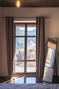 a bedroom with a large window with a view at Valtesiniko View in Valtessiniko 