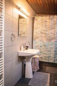 a bathroom with a white sink and a mirror at Valtesiniko View in Valtessiniko 