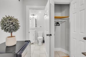a bathroom with a toilet and a plant on a counter at Fairmount Oasis 1BR Haven in Philadelphia