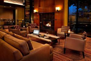 a living room with a couch and a fireplace at Courtyard Seattle Sea-Tac Area in Tukwila