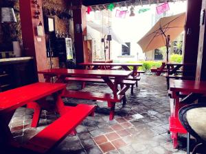 a row of wooden tables and benches in a restaurant at Hotel Boutique Tierra Magica in Tequila