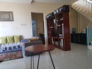 a living room with a couch and a table at Villa Batu Iggy in Batu