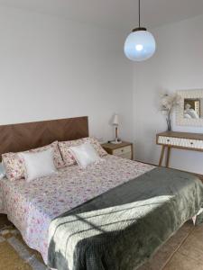 a bedroom with a large bed with pillows at La Casa del San Antón in Níjar