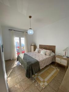 a bedroom with a bed and a large window at La Casa del San Antón in Níjar