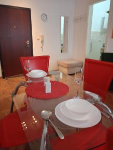 a table with two plates and wine glasses on it at Clockwork orange apartment in Vračar (historical) +15 photos
