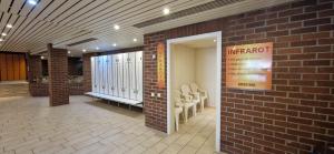 a lobby of a building with a brick wall at Sauna, Pool und Gartenzugang oder Balkon in Sankt Englmar