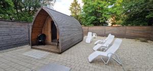 a group of white chairs sitting outside of a tent at Sauna, Pool und Gartenzugang in Sankt Englmar