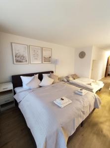 a bedroom with a large bed with two towels on it at Sauna, Pool und Gartenzugang in Sankt Englmar