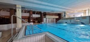 a large indoor swimming pool in a building at Sauna, Pool und Gartenzugang oder Balkon in Sankt Englmar