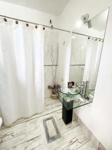 a bathroom with a glass sink and a mirror at Hotel Boutique in Mina Clavero