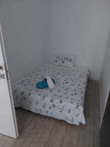 a small bed in a small room with a bedspread on it at Astoria Apartament vedere la mare in Mamaia Sat/Năvodari