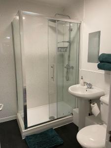 a bathroom with a shower and a sink at Modern 2 BDR Flat in Nottingham City Centre with FREE Parking in Nottingham