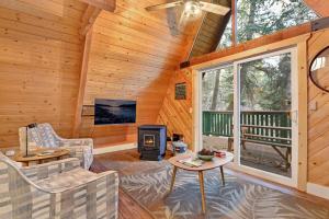 a living room with a fireplace and a stove at Whispering Woods Big Bear~ Central Resort Cottage~ in Big Bear Lake