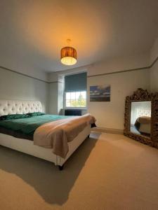 a bedroom with a large bed and a mirror at High street, Bruton in Bruton