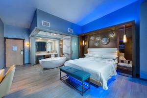 a bedroom with a large bed and a bath tub at Shade Hotel Manhattan Beach in Manhattan Beach