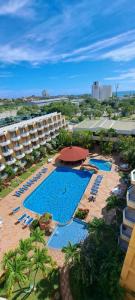 an aerial view of a resort with a swimming pool and a hotel at Departamento Tipo Estudio Dynasty Isla de Margarita in Porlamar