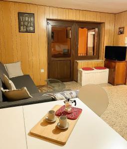 a living room with a table with two cups on it at B&B da Lule in Aosta