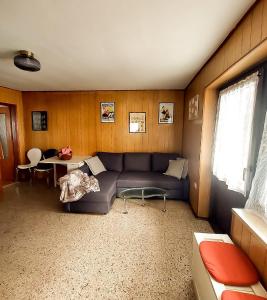 a living room with a couch and a table at B&B da Lule in Aosta