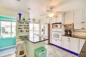 a kitchen with white cabinets and a counter top at Riverfront Townhome in Titusville Community Pool in Titusville