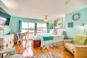 a bedroom with blue walls and a bed and a chair at Riverfront Townhome in Titusville Community Pool in Titusville