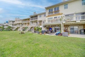 a large apartment building with a lawn in front of it at Riverfront Townhome in Titusville Community Pool in Titusville