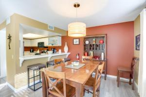 a kitchen and dining room with a wooden table and chairs at Cathedral City Condo with Community Pools and Hot Tubs in Cathedral City