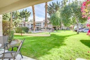 a yard with palm trees and a house at Cathedral City Condo with Community Pools and Hot Tubs in Cathedral City