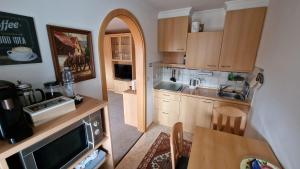 a small kitchen with a table and a counter top at FeWo AllgäuZeit mit Hallenbad & Sauna & kostenlosem WLAN in Missen-Wilhams