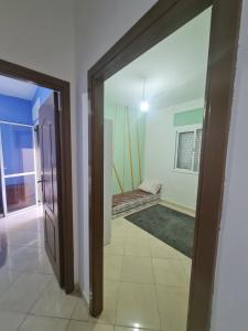 a room with a door leading to a room with a window at appart hotel tanger gzenaya in Tangier