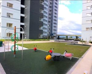 a park with a table and some toys in it at Avida Towers Davao City by darpm in Davao City