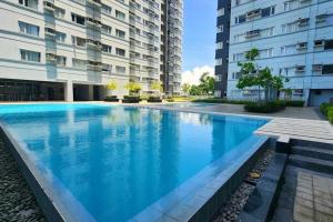 a large swimming pool in front of a building at Avida Towers Davao City by darpm in Davao City
