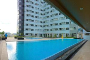 a large apartment building with a large swimming pool at Avida Towers Davao City by darpm in Davao City