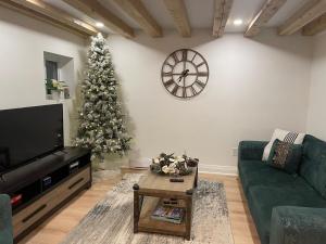 a living room with a christmas tree and a tv at Cozy Cottage Style House in Kitchener