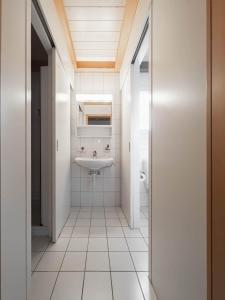 a bathroom with a sink and a toilet at Chalet Wassermandli in Lenk