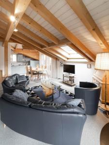 a living room with a large couch and a table at Chalet Wassermandli in Lenk