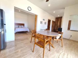 a room with a table and chairs and a bed at Pool Condo, just a few steps from the beach -north in Los Barriles