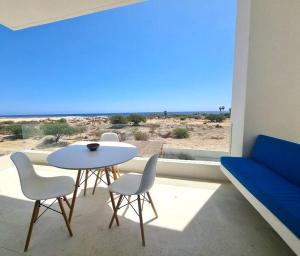 a room with a table and chairs and a view of the beach at Pool Condo, just a few steps from the beach -north in Los Barriles