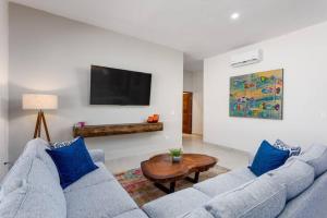 a living room with two blue couches and a table at Walkable, Convenient in Downtown Los Barriles in Los Barriles