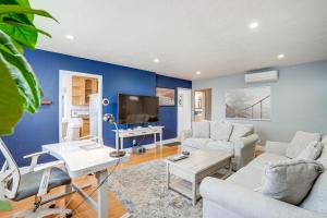 a living room with a blue wall at Oakland Apartment with Shared Hidden Backyard Oasis! in Oakland