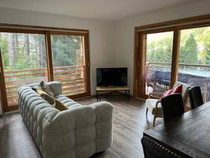 a living room with a couch and a television at Les Chalets de Montriond B101 By Avecoeur in Montriond