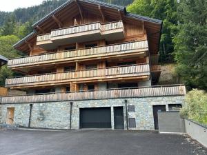 a large building with a balcony on top of it at Les Chalets de Montriond B101 By Avecoeur in Montriond