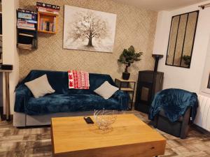 a living room with a couch and a coffee table at Chez Gwen et Marie in Bogny Sur Meuse