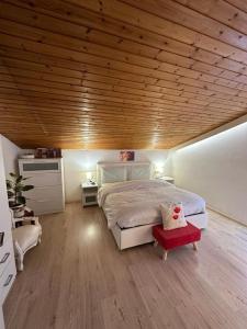 a bedroom with a large bed and a wooden ceiling at Plose Panorama House in Bressanone