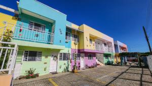 a group of buildings with colorful paint on them at Apart Pousada Villa das Flores in Penha