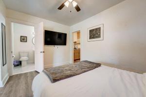 a bedroom with a bed and a flat screen tv at Enchanting Home In Ideal Downtown Location in Oklahoma City