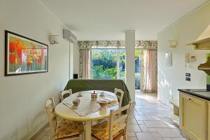 a kitchen and dining room with a table and chairs at Casa Vacanze Nel Giardino di Renzo in Imperia