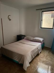 a bedroom with two beds and a window at Crisana - jerez in Floridablanca